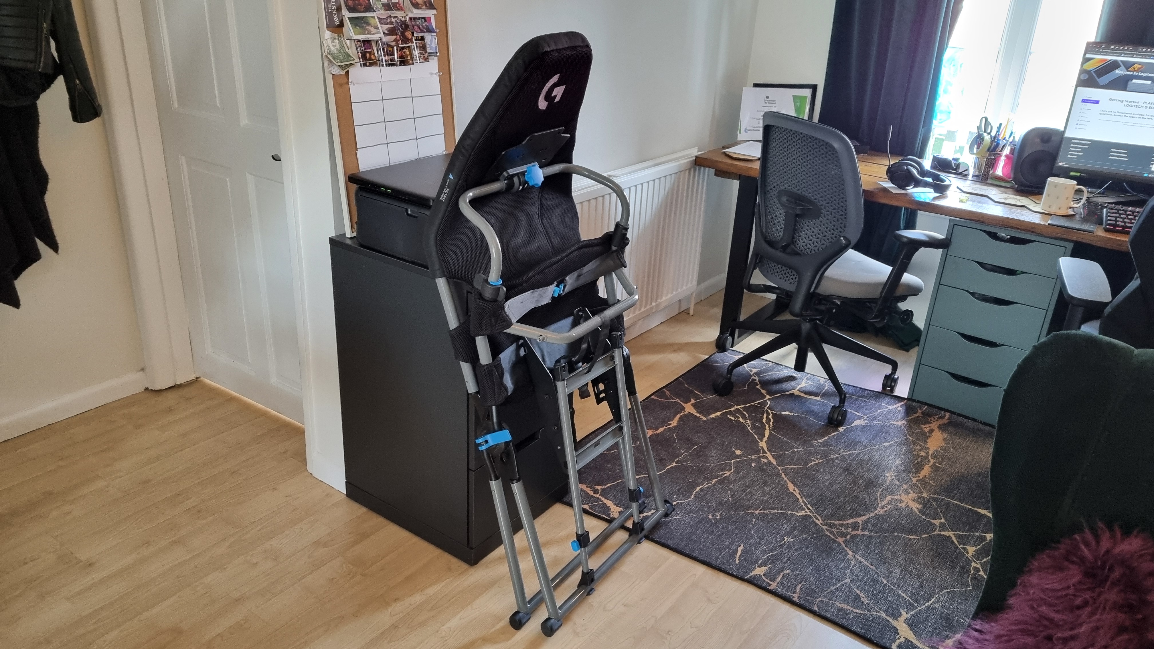 The Logitech Playseat Challenge X, folded up against a filing cabinet