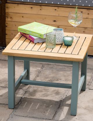 wooden outdoor table with books and candles