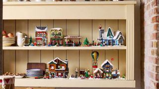 Lego Christmas Village set up on wooden shelves