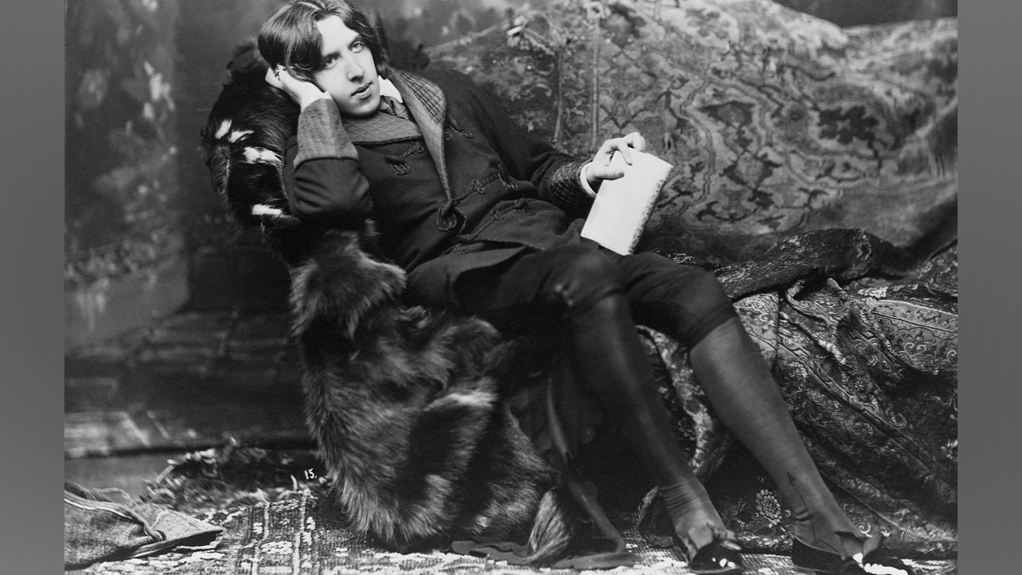 Oscar Wilde lying in a bed-chair.