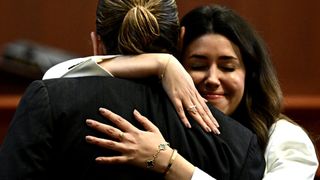 Attorney Camille Vasquez embraces US actor Johnny Depp in the courtroom at the Fairfax County Circuit Courthouse in Fairfax, Virginia, on May 17, 2022.