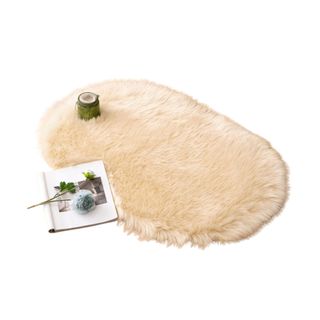 A fluffy rug with a book and flowers on it