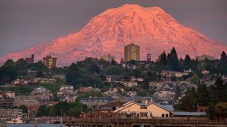 The famous Mount Rainier looms over Tacoma, WA at sunset