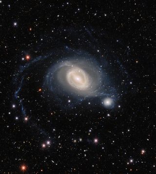 The interacting galaxy pair NGC 1512 and NGC 1510 take center stage in this image from the Dark Energy Camera on the Víctor M. Blanco 4-meter Telescope at Cerro Tololo Inter-American Observatory in Chile.