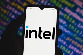 Intel logo appearing on a smartphone in front of blurred background of code