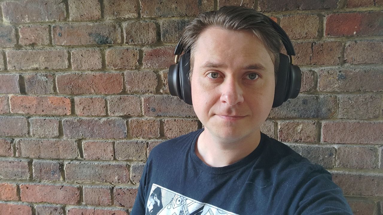 Photograph of man wearing DALI iO-12 headphones