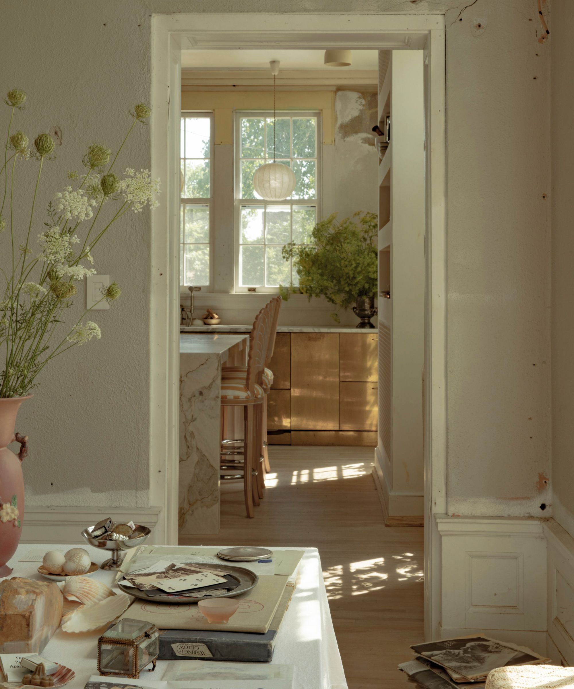 a historic building reimagined with a brass kitchen and vintage decor