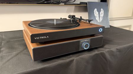 The Victrola Soundstage at CES 2026, under a Victrola Wave turntable, both in a matching wood finish