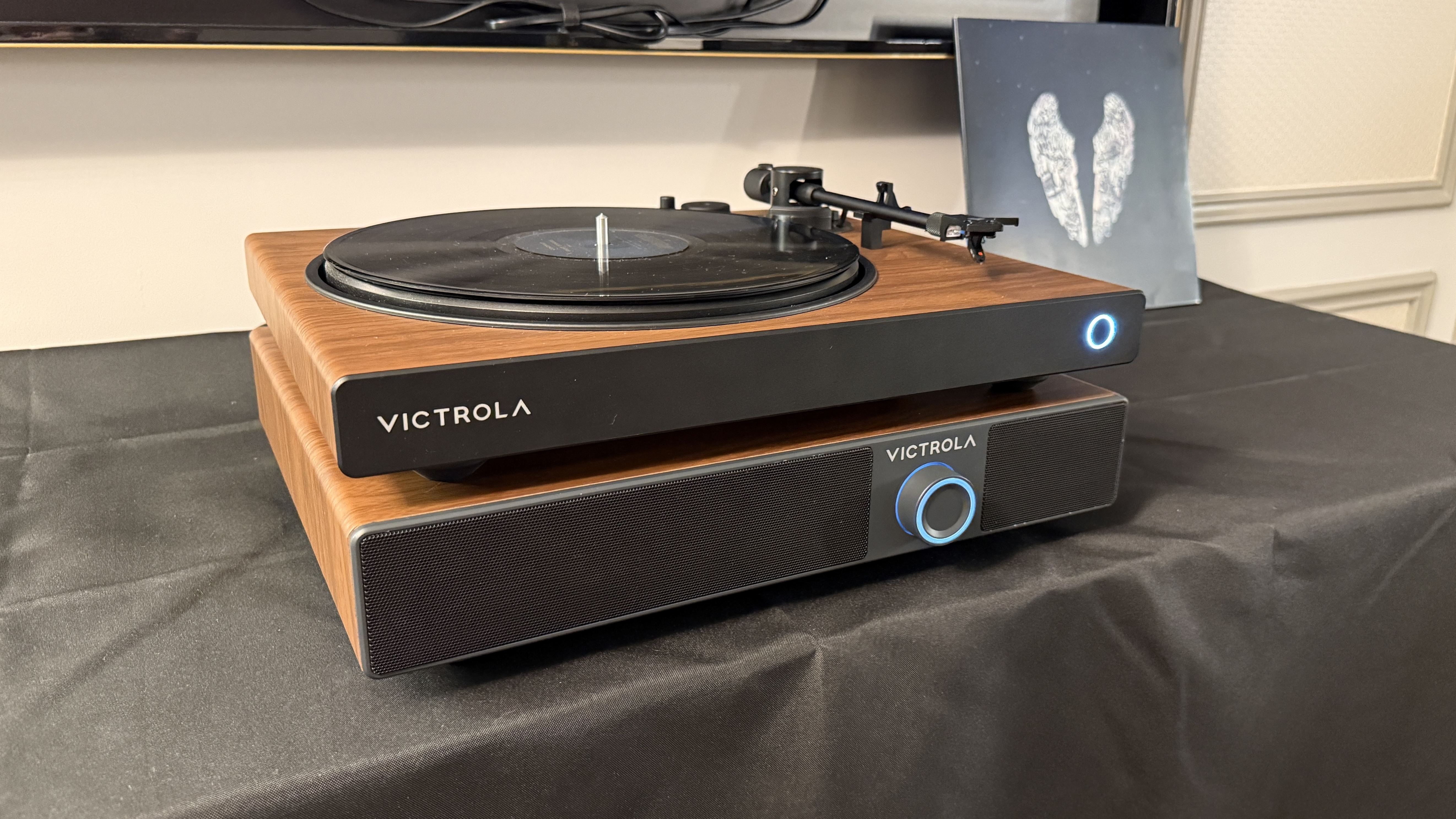 The Victrola Soundstage at CES 2026, under a Victrola Wave turntable, both in a matching wood finish