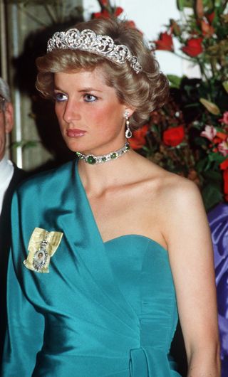Princess Diana wears a tiara and a choker