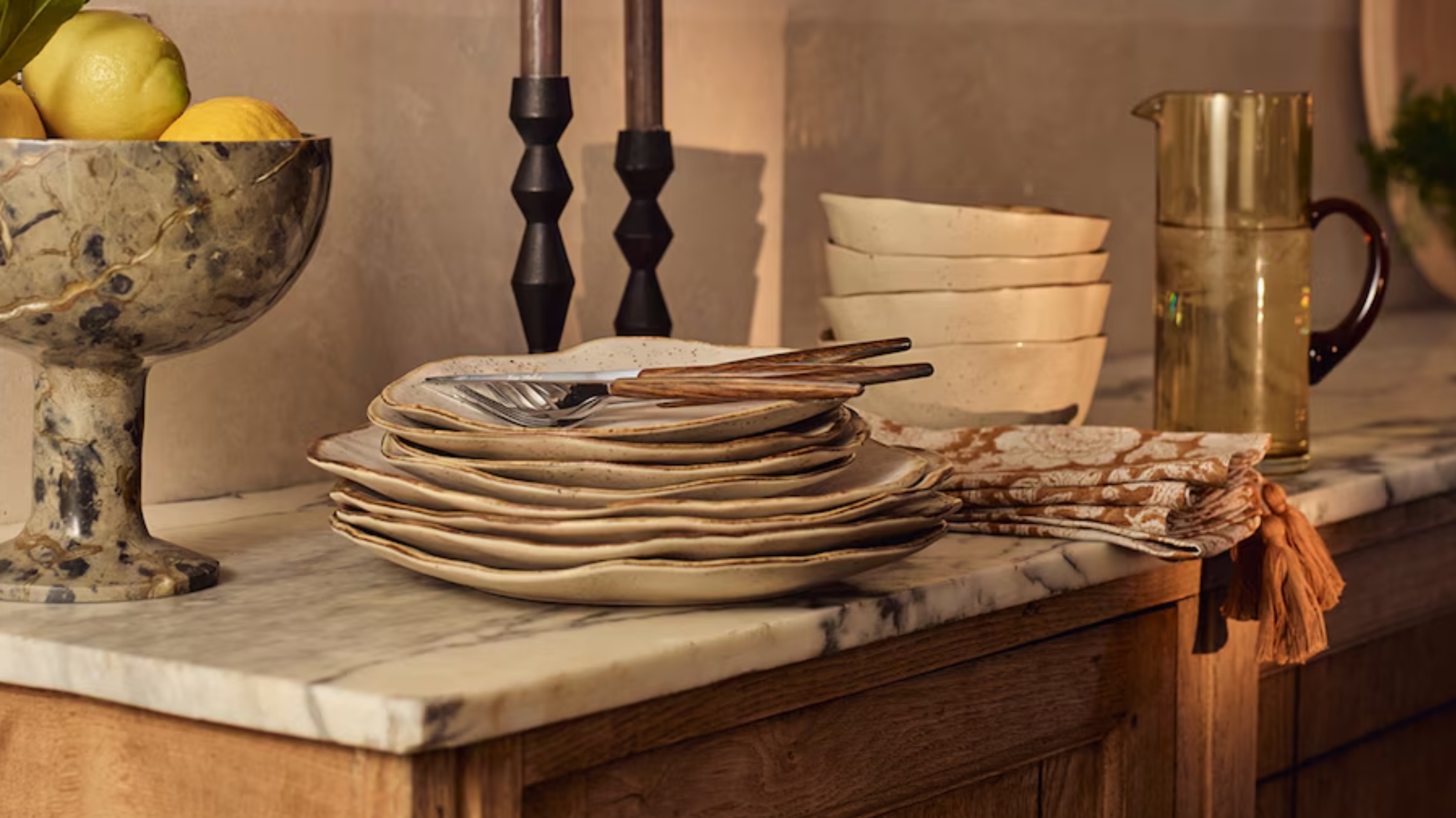 a stack of organically shaped plates on a kitchen side
