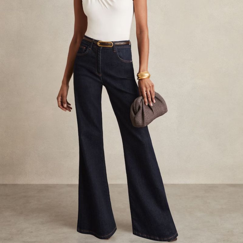 Bonnie Mid-Rise Flared Jeans in Dark Blue on model 
