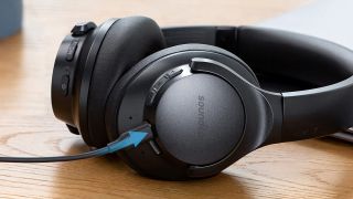 Best budget wireless headphones: Soundcore by Anker Life Q20 on a wooden table