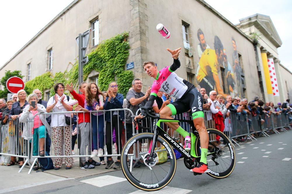 Sep Vanmarcke tosses a bottle to the crowd at the 2018 Tour de France team presentation