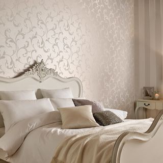 bedroom with wallpaper and pillows