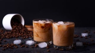Two glasses with a cocktail in them made from alternative milk and coffee