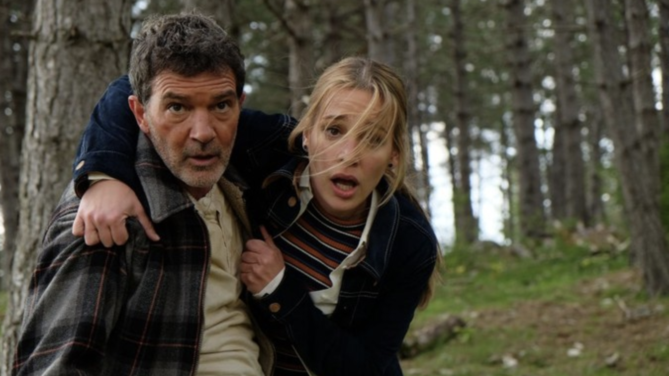 A still from the movie Black Butterfly showing Antonio Banderas as Paul Lopez and Piper Perabo as Laura Johnson looking distressed in the woods