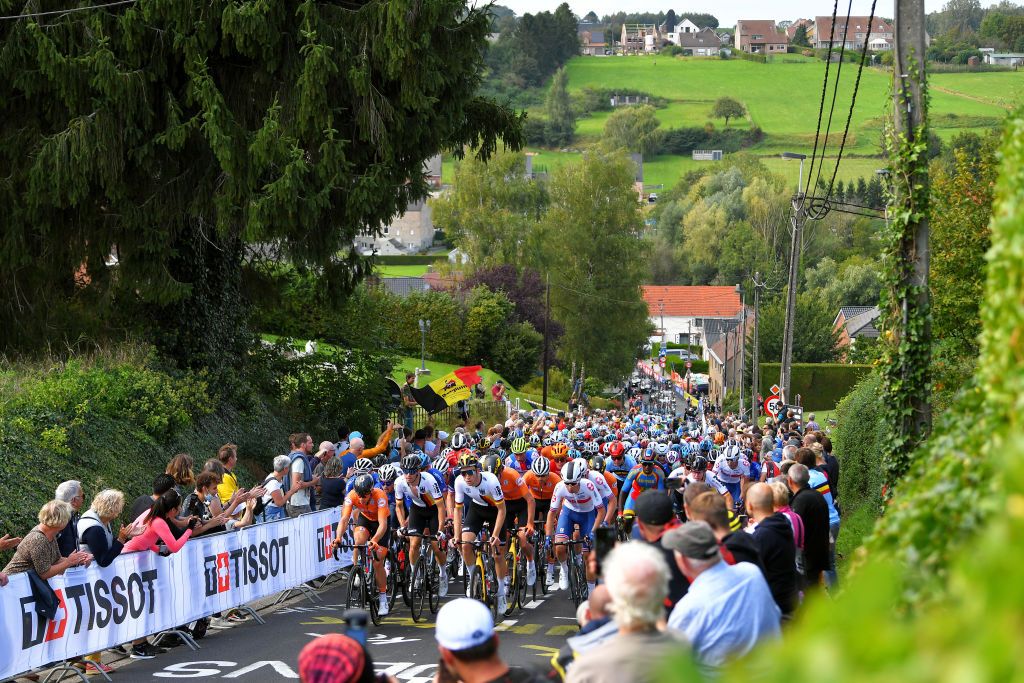 LEUVEN BELGIUM SEPTEMBER 24 A general view of the Peloton passing through Smeysberg 95m while fans cheer during the 94th UCI Road World Championships 2021 Men U23 Road Race a 1609km race from Antwerp to Leuven flanders2021 on September 24 2021 in Leuven Belgium Photo by Luc ClaessenGetty Images