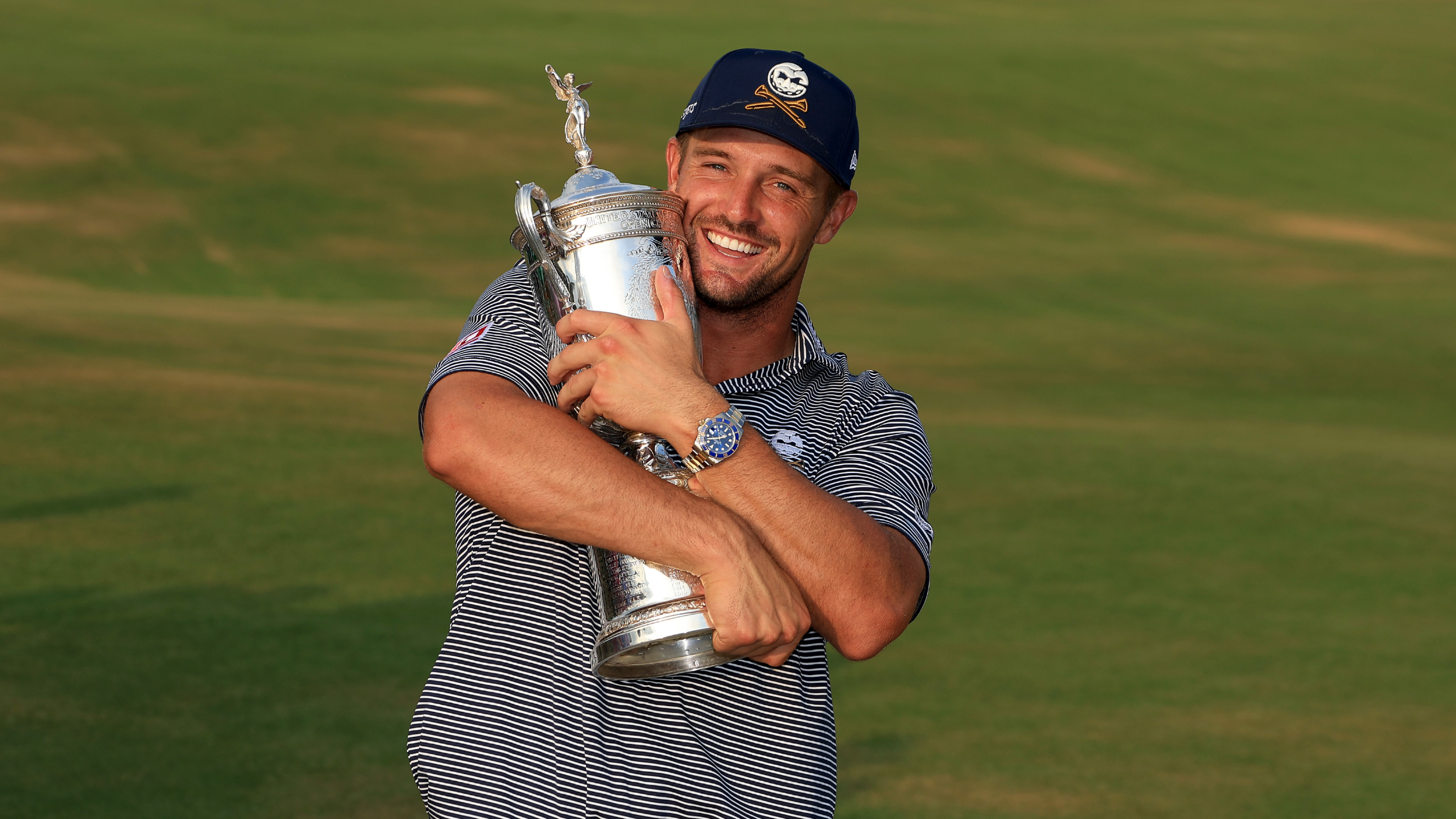 Bryson DeChambeau embraces the US Open trophy