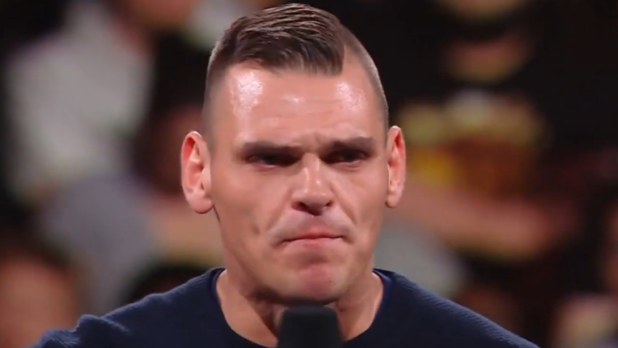 Gunther delivers an angry promo in the ring.
