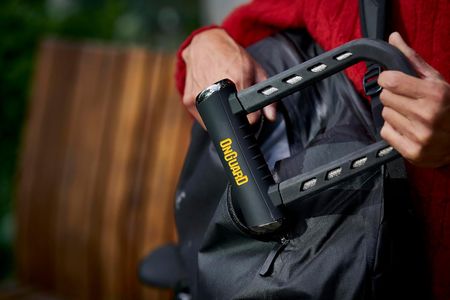 The OnGuard RockSolid U-Lock being placed in a backpack