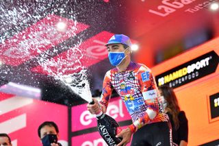 ROCCARASO ITALY OCTOBER 11 Podium Ruben Guerreiro of Portugal and Team EF Pro Cycling Celebration Champagne during the 103rd Giro dItalia 2020 Stage 9 a 207km stage from San Salvo to Roccaraso Aremogna 1658m girodiitalia Giro on October 11 2020 in Roccaraso Italy Photo by Stuart FranklinGetty Images