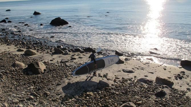 Mary McConneloug heads out for a stand-up paddleboard session