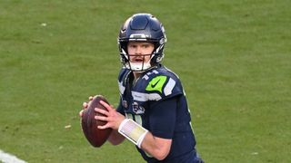 Sam Darnold #14 of the Seattle Seahawks drops back to pass against the New England Patriots during the second quarter in Super Bowl LX.
