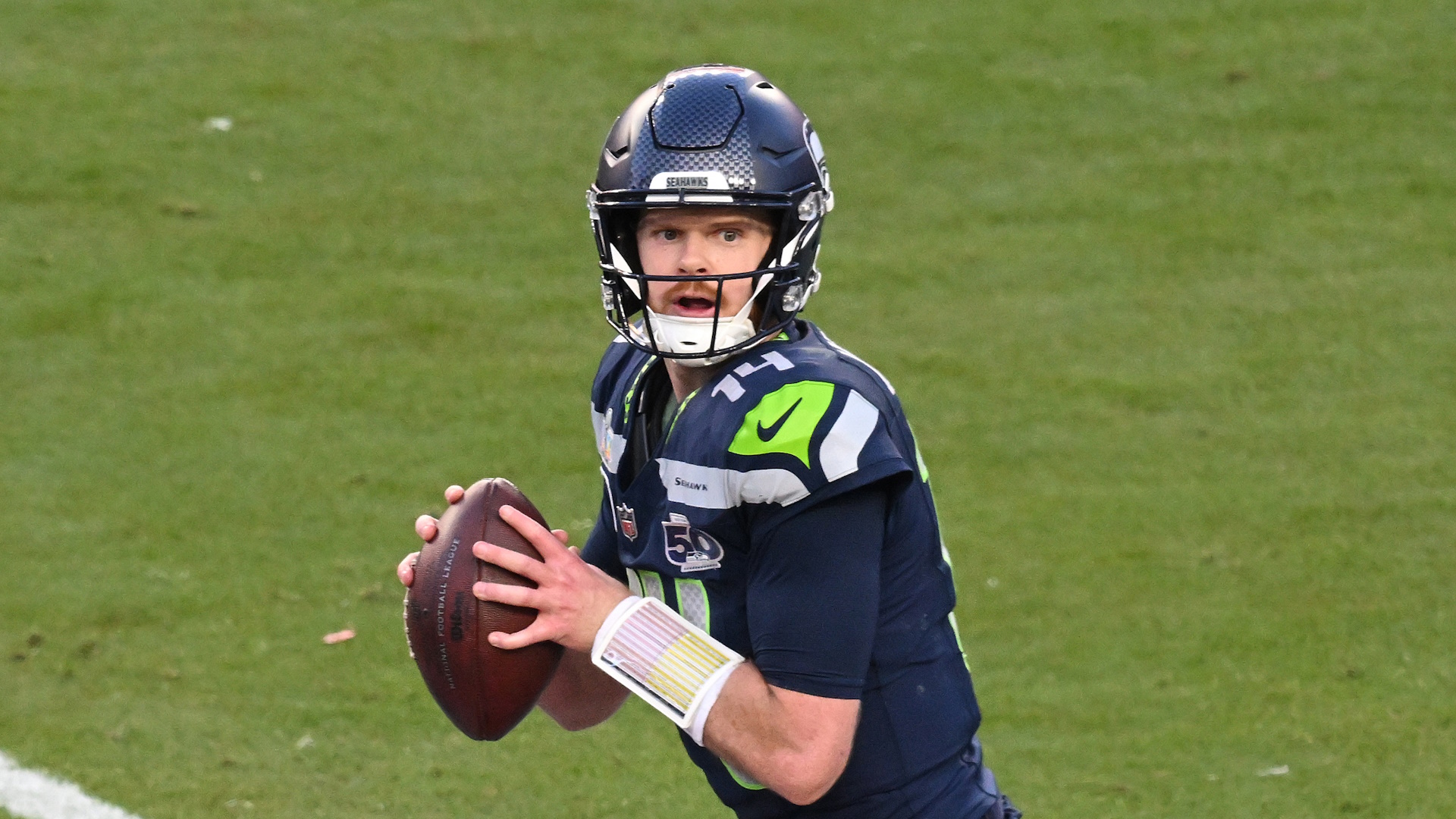Sam Darnold #14 of the Seattle Seahawks drops back to pass against the New England Patriots during the second quarter in Super Bowl LX.