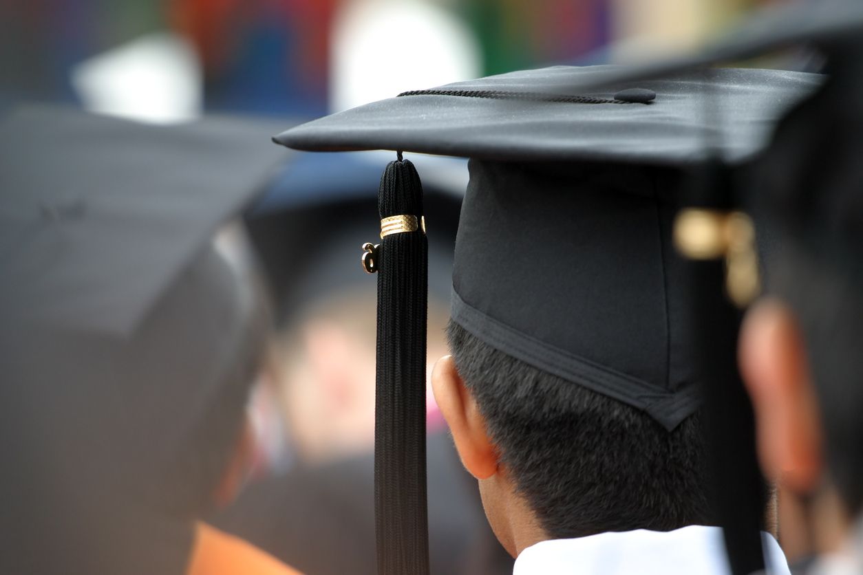 Graduate listening to speaker.