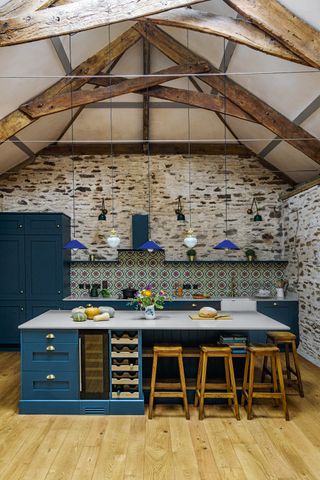 Kitchen in a barn conversion with ceiling pendant lights
