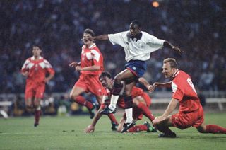 Ian Wright for England, getting between two Polish players to shoot. Picture taken 8th September 1993. England versus Poland at Wembley Stadium, London. World Cup 94 Qualifying Group 2. Final score England (3) v Poland (0) (Photo by Brendan Monks/Mirrorpix via Getty Images)