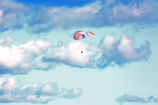 Guided by four parachutes, the SpaceX Crew Dragon capsule genty drifts back down to Earth after spending nearly a week at the International Space Station for its first mission. The uncrewed capsule splashed down in the Atlantic Ocean on Friday (March 8) at 8:45 a.m. EST (1345 GMT).