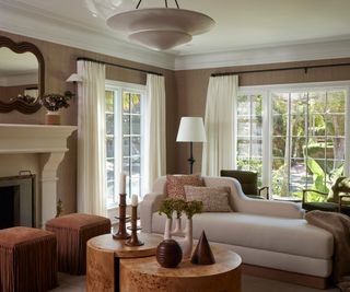 living room with taupe walls and white chaise sofa with two coffee tables and doors to garden