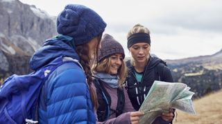 Three women looking at map