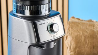 the breville dose control pro, called sage dose control pro in the uk, a silver coffee grinder with 60 grind settings and labeled grind size adjustment