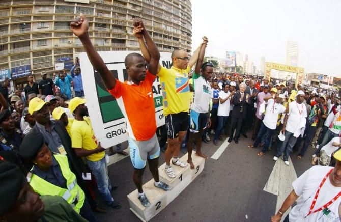 Togo's Monglo Toure, France's Mederic Clain and Rwanda's Emile Bintu Dinano celebrate on stage 3 podium in the Democratic Republic of Congo cycling Tour