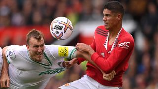 Newcastle United defender Dan Burn has his shirt pulled by Manchester United defender Raphael Varane during a Premier League match between Manchester United and Newcastle United