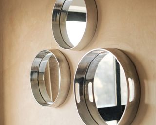 hot metals trend with metal mirrors, three, on off-white wall