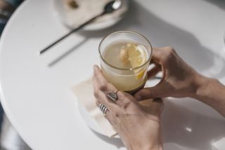 Norovirus symptoms: A woman holding a mug of ginger tea