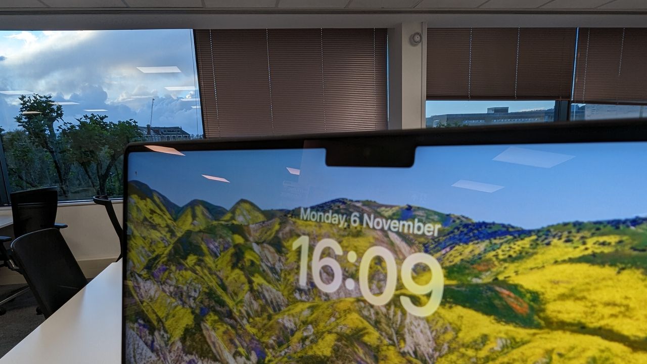 MacBook Pro 16-inch with screen open in an office