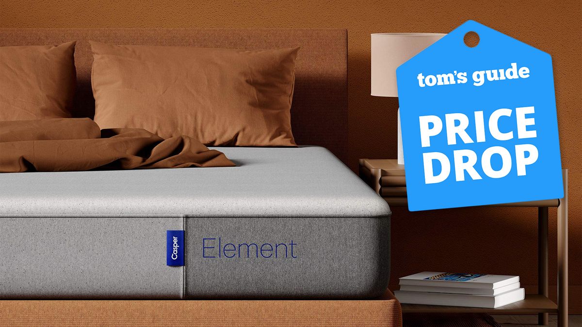 A Casper Sleep Elements mattress on a bed frame in a bedroom next to a bedside table, a Tom&#039;s Guide price drop deals graphic to the right