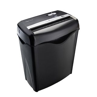 A black standing paper shredder with a bin