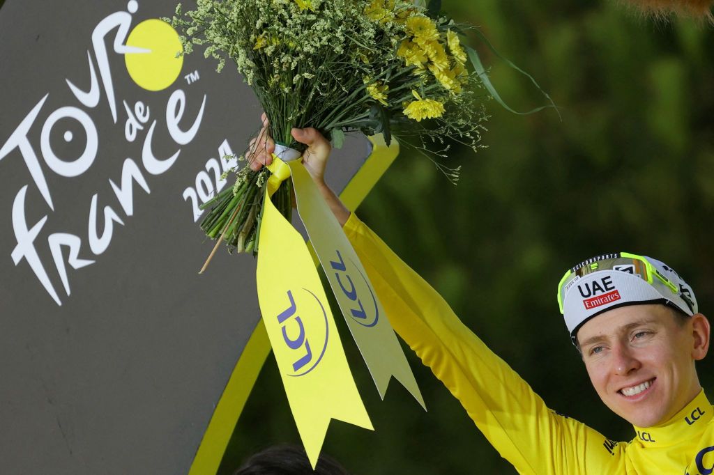 UAE Team Emirates team&#039;s Slovenian rider Tadej Pogacar celebrates his overall victory on the podium with the overall leader&#039;s yellow jersey after the 21st and final stage of the 111th edition of the Tour de France cycling race, a 33,7 km individual time-trial between Monaco and Nice, on July 21, 2024. (Photo by Thomas SAMSON / AFP)