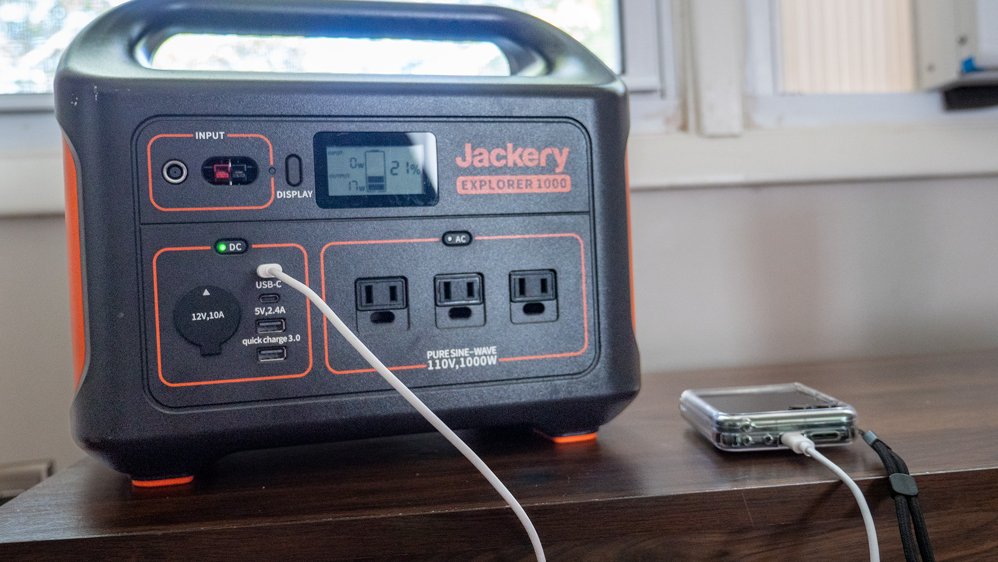 A Jackery Explorer 1000 power bank charging a Motorola Razr Plus 2024