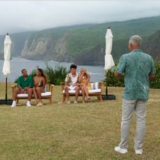 The cast of 'Temptation Island' (l-r Summit Wallace, Kaylee Needham, Cole Mueller, Scarlett Bentley, Mikey Bivens, Sydney McGregor, Mark L. Walberg) films on a cliff in Hawaii.