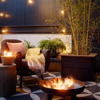 Outdoor seating around firepit with festoon lighting