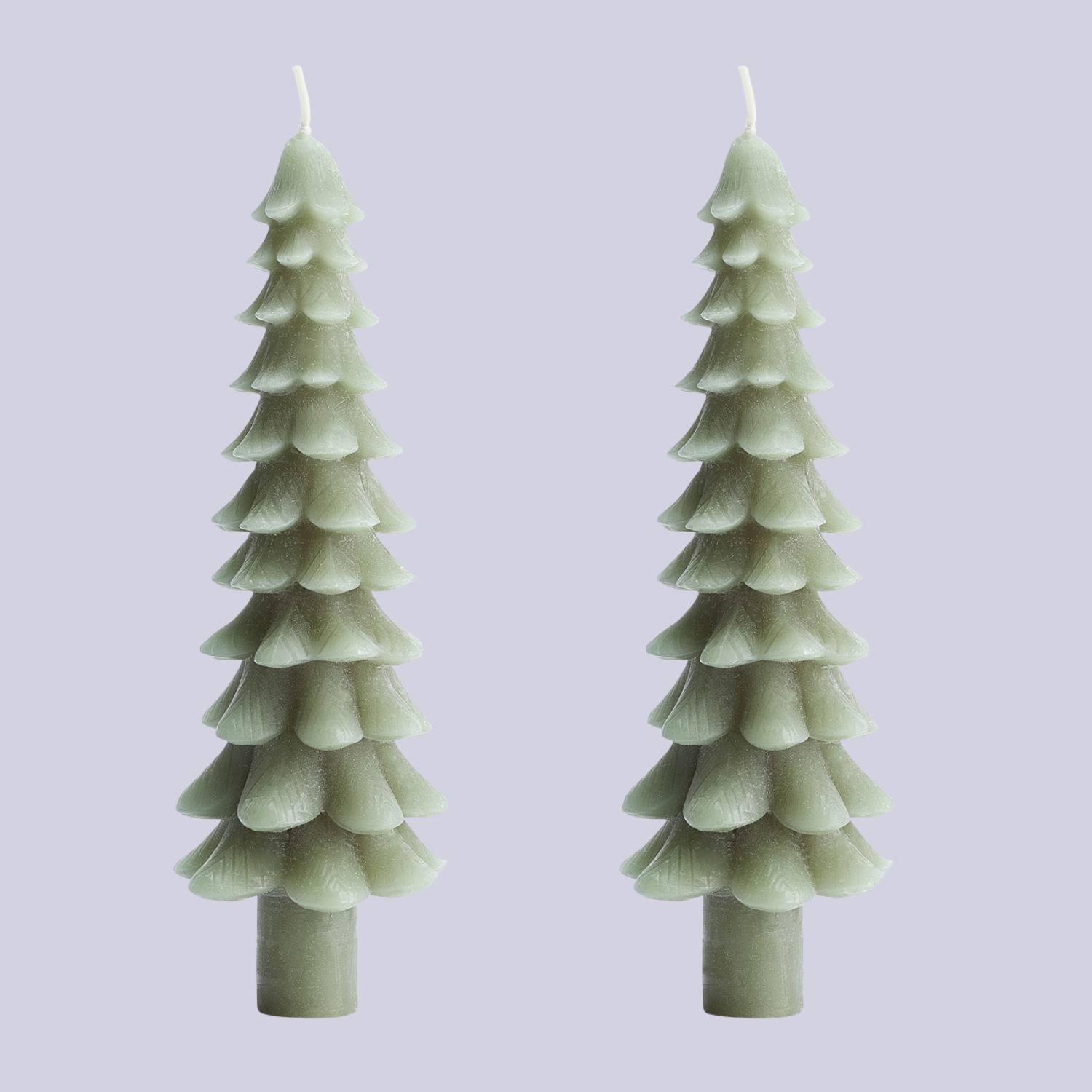 A pair of green Christmas tree taper candles