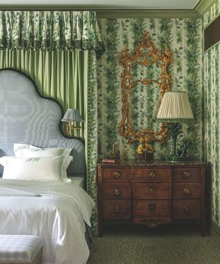 Bedroom with patterned walls and bed curtains