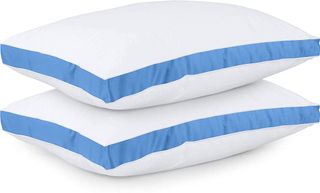 Best pillows: the Utopia Bedding Gusseted Pillows duo in white with a thick blue band around the middle of the pillow